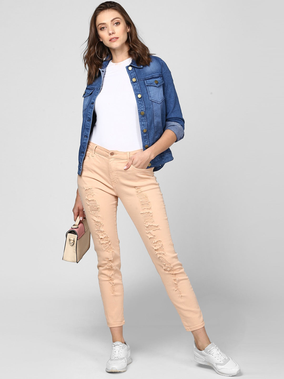 Stylish denim jacket for contemporary women, paired with casual beige chinos and white sneakers, creating a versatile and fashion-forward look.