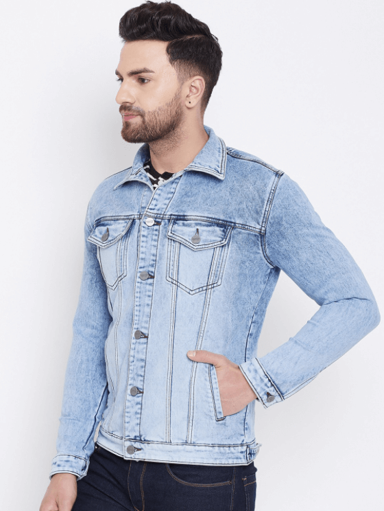 Light blue denim jacket with chest pockets, worn by a young man with a beard against a white background.