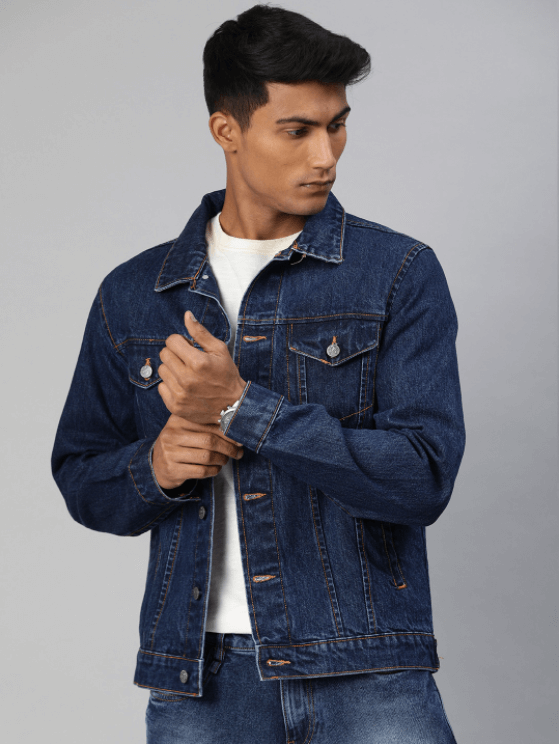 Dark blue denim jacket with metal buttons and pockets worn by a young man against a plain white background.