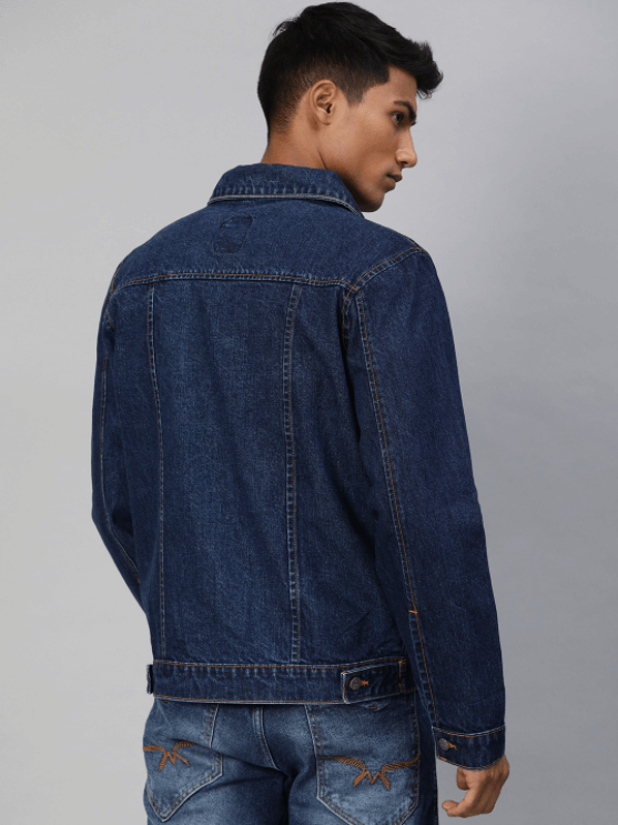 Dark blue denim jacket worn by a young male model against a plain background.