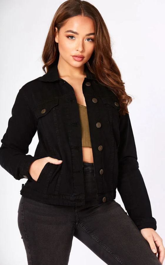 Black solid women's denim jacket with front buttons and pockets on display against a white background.