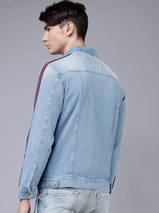 A light blue denim jacket worn by a young male model against a grey background.