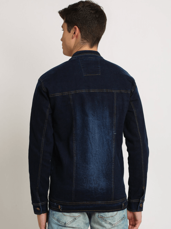 Mens dark blue denim jacket with button closure and stitched details, worn by a male model in the image.