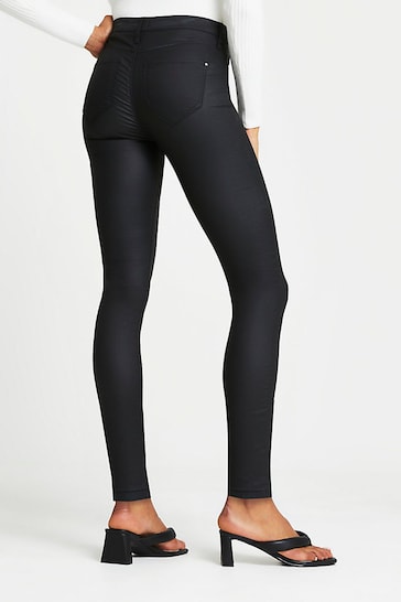 Stylish black coated skinny jeans with a slim, form-fitting silhouette, featured in the Ace Cart product image.
