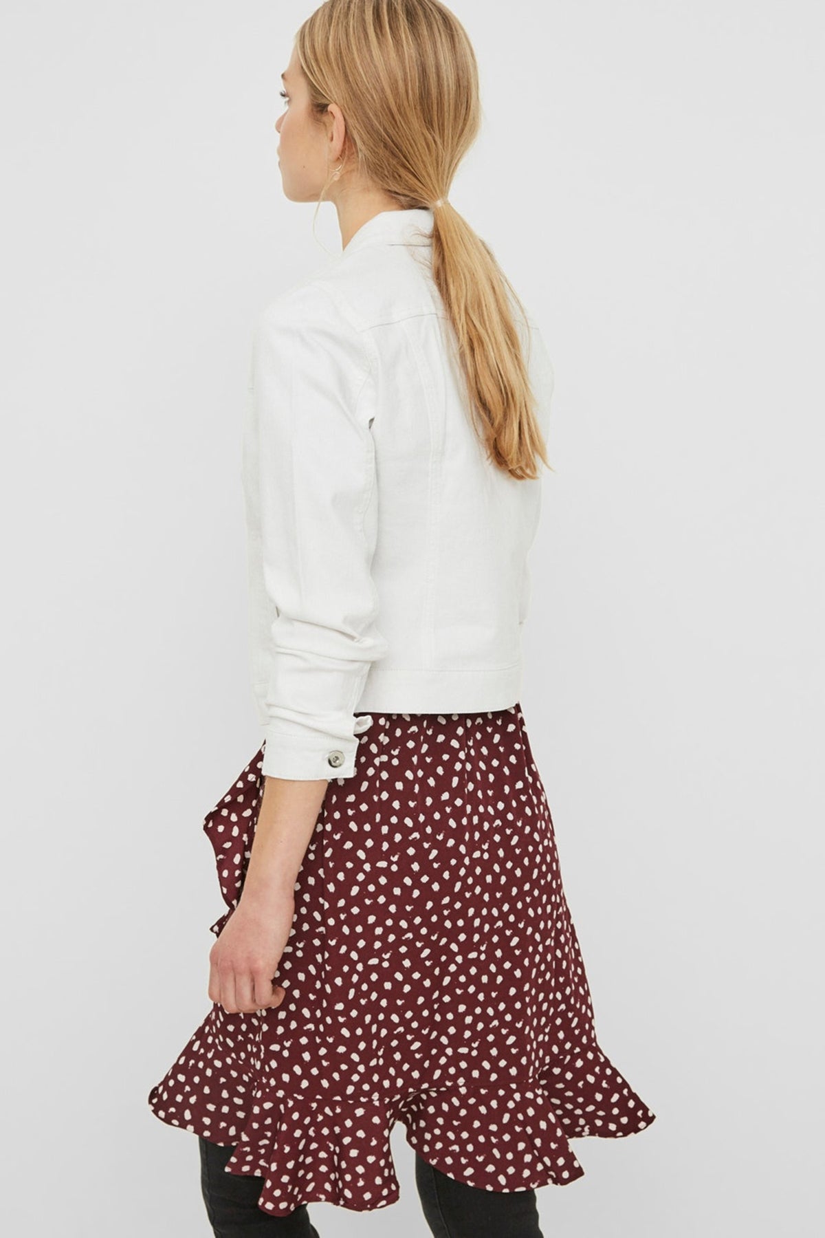 Stylish white jacket for women, long sleeve fitted design, paired with a red patterned skirt, creating a trendy casual outfit.