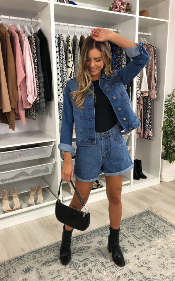 Stylish blue denim jacket and shorts outfit on display in a clothing store.