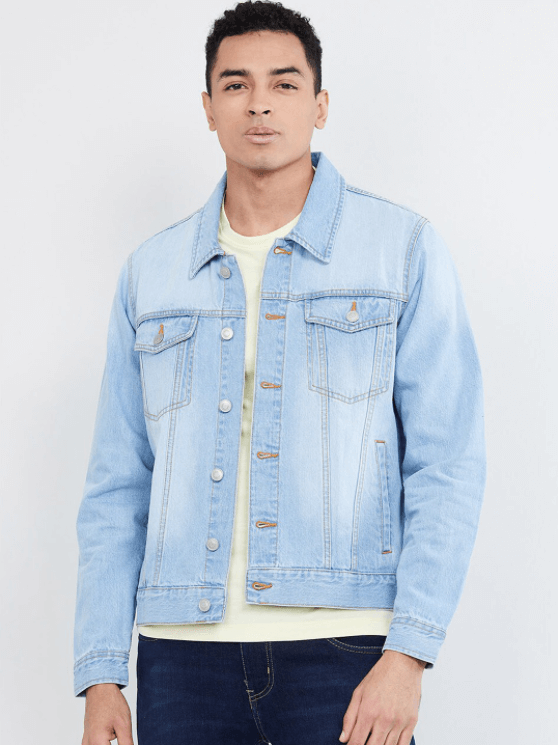 Light blue denim jacket with front pockets worn by a young male model against a plain white background.
