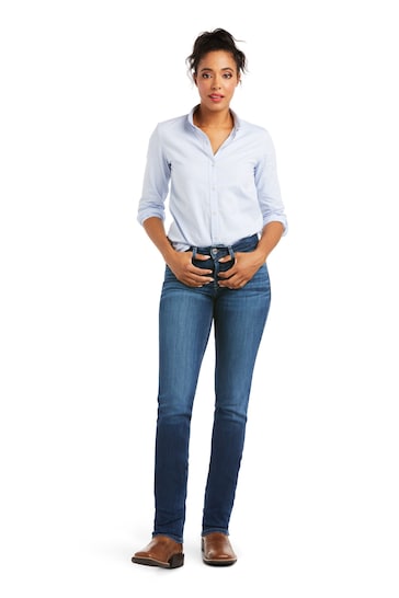 High-quality Ariat blue jeans with perfect rise and straight leg fit modeled by a woman in a white studio setting.