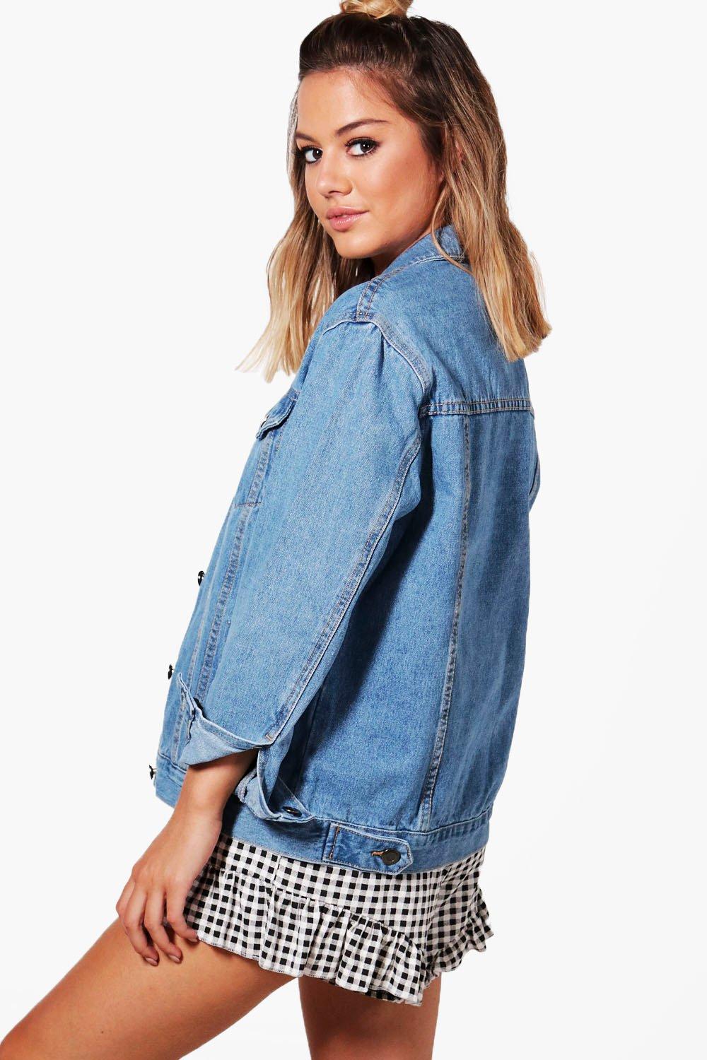 Women's blue denim jacket with long sleeves and a collared neckline, showcased on a female model standing with a side view