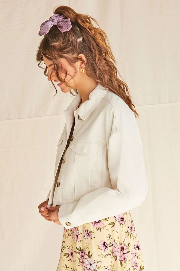 Woman's white solid jacket with floral skirt.