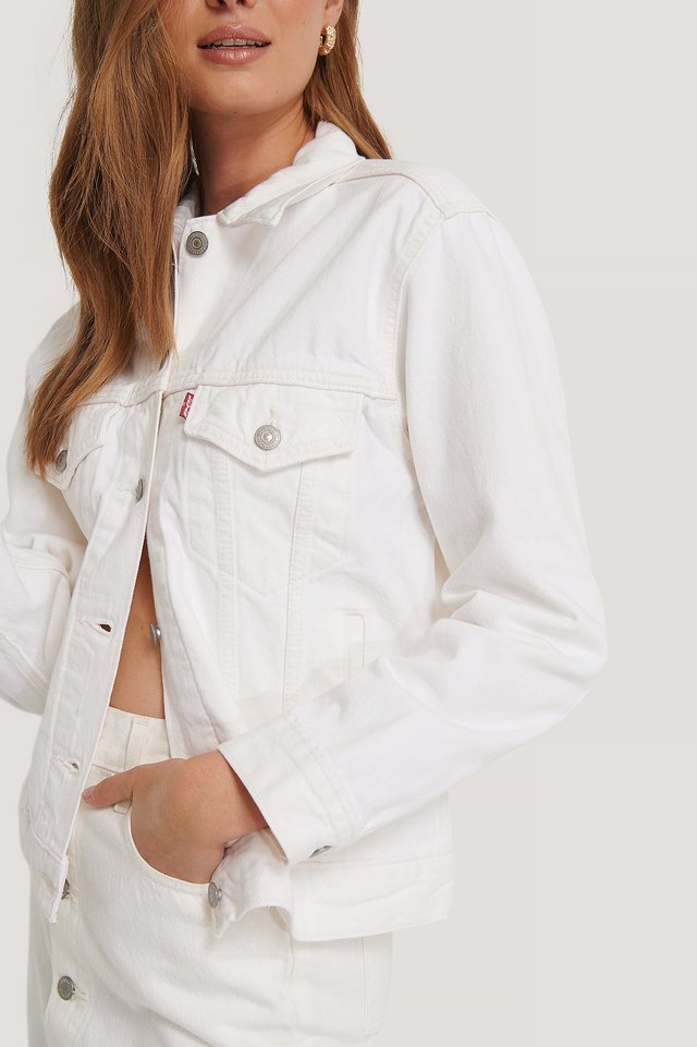 Stylish white denim jacket from Ace Cart featuring a cropped, boxy silhouette and functional front pockets for versatile women's fashion.
