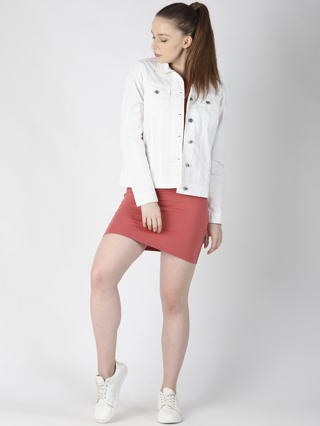 White solid women's denim jacket, red mini skirt, and white sneakers on a white background.