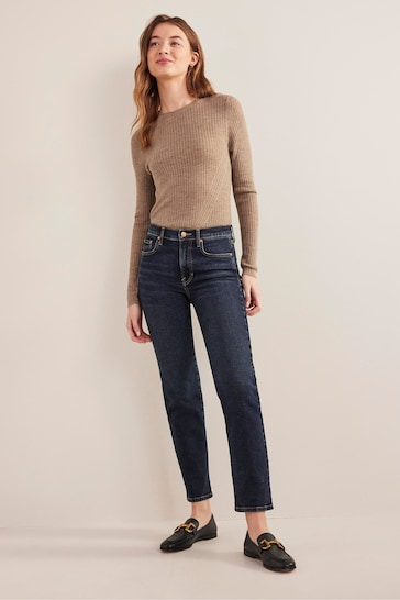 Stylish woman wearing Boden Blue Mid Rise Cigarette Jeans, a cozy taupe sweater, and trendy loafers against a neutral background.