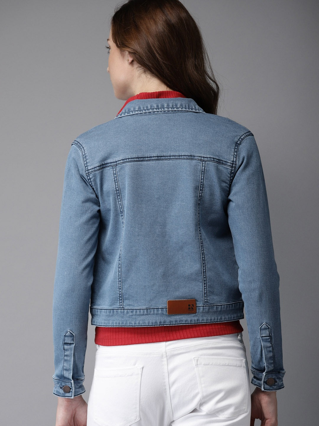 Stylish blue denim jacket with white stitching for fashionable women