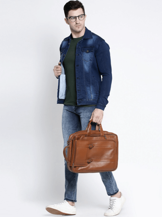 Stylish dark blue denim jacket worn by a young man carrying a brown leather briefcase.