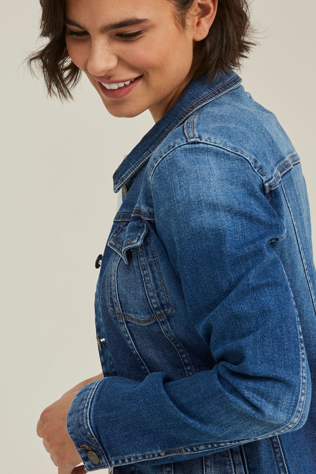 Blue denim jacket for stylish women, featuring a crop cut and bold buttons for a fashionable look.