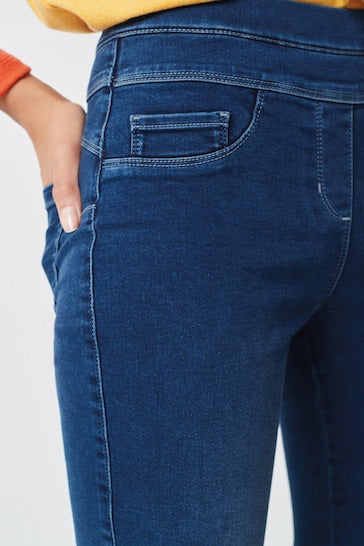 Super Stretch Soft Sculpt Pull-On Slim Leggings in dark denim from Ace Cart featuring pockets and a figure-flattering silhouette.