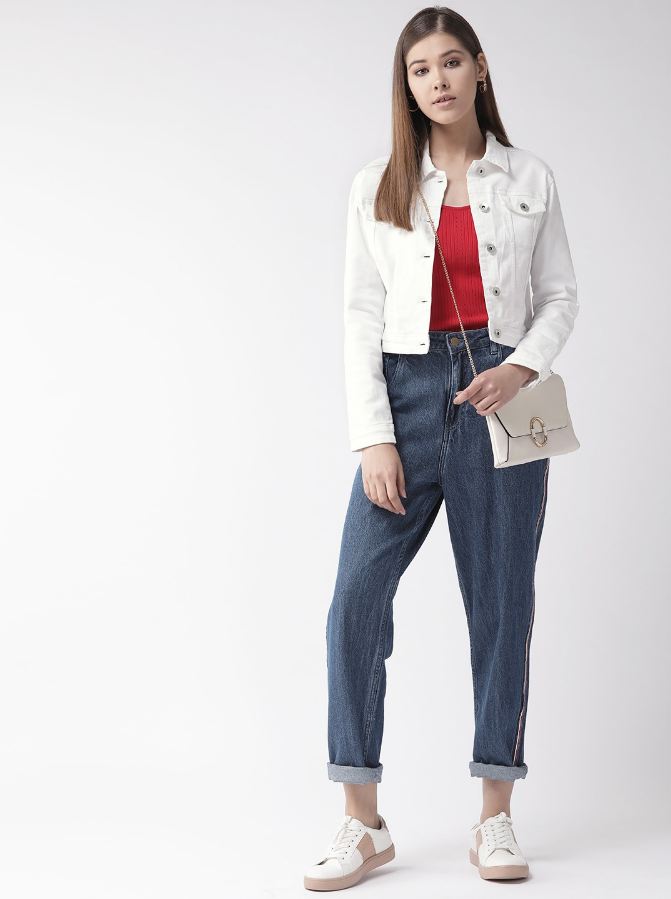 Women's white solid denim jacket, styled with red top and high-waisted jeans, paired with white sneakers.