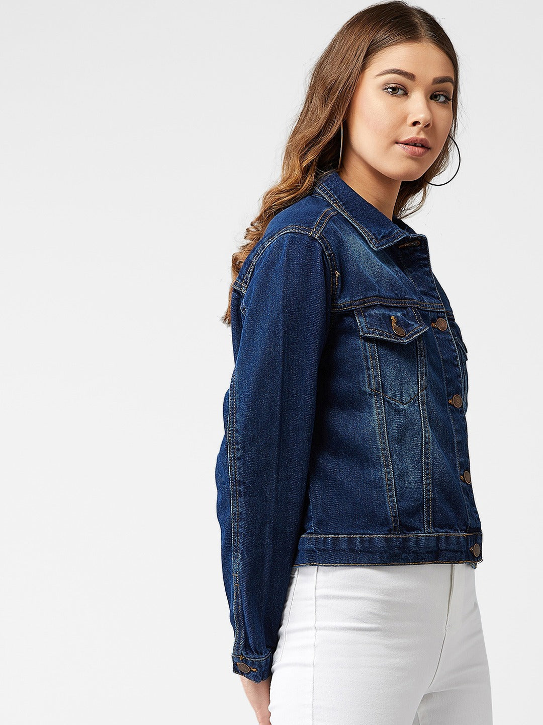 Women's blue solid denim jacket with classic design and pockets, shown in a studio setting.