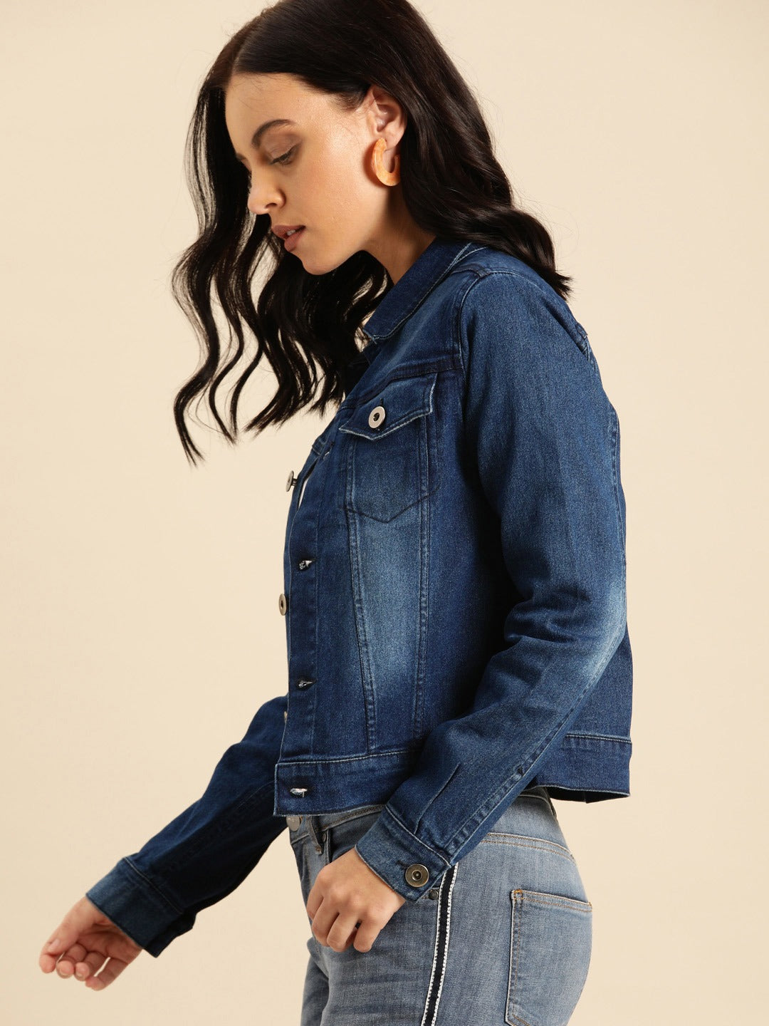 Dark blue washed denim jacket for women, featuring a classic collar and button-up design.