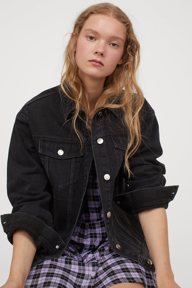 Black denim jacket for stylish women, featuring classic button design and relaxed fit.