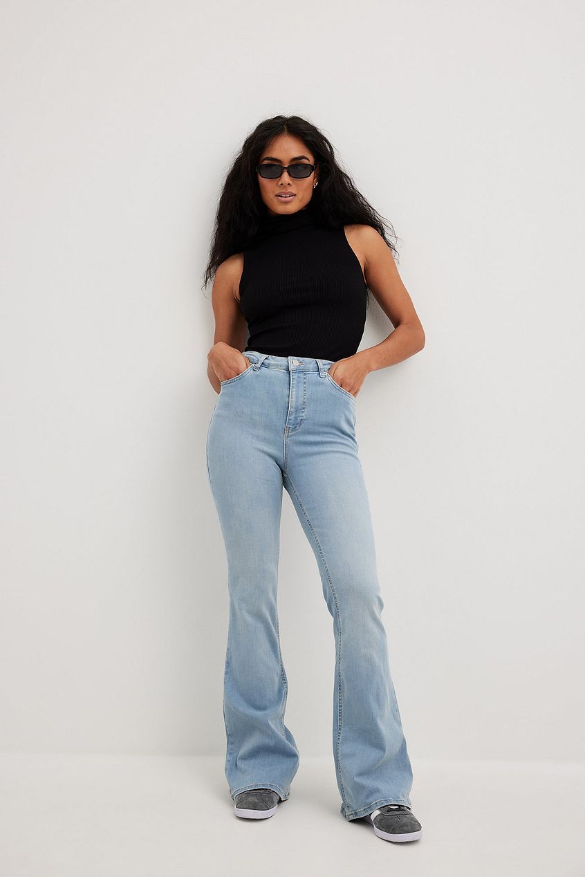Flared High Waist Stretch Jeans with model in black top and sunglasses