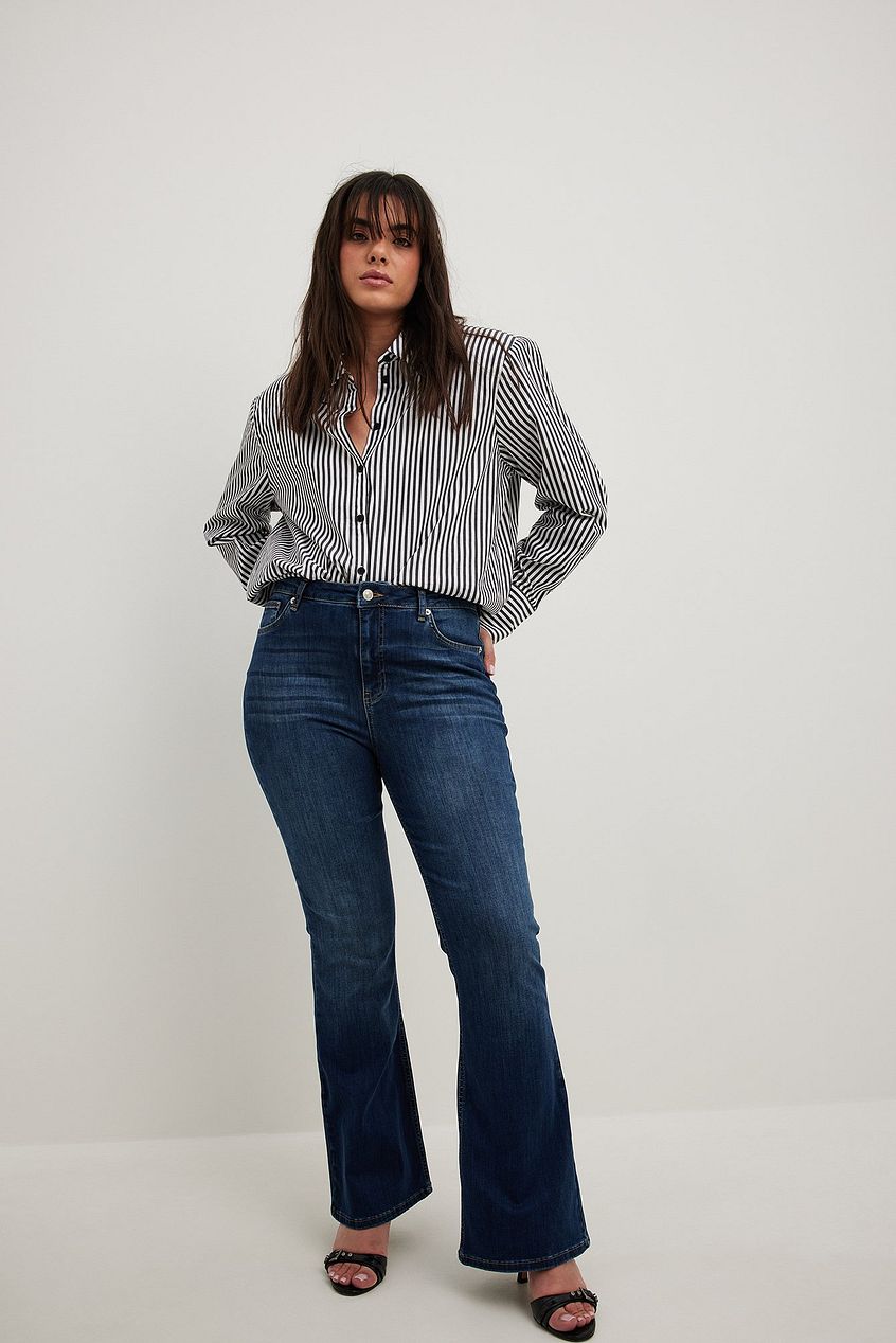 Flared High Waist Stretch Jeans by Ace Cart - Stylish woman wearing denim jeans with a striped blouse