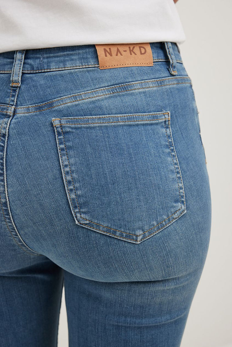 High-waist flared stretch denim jeans with Na-kd brand label