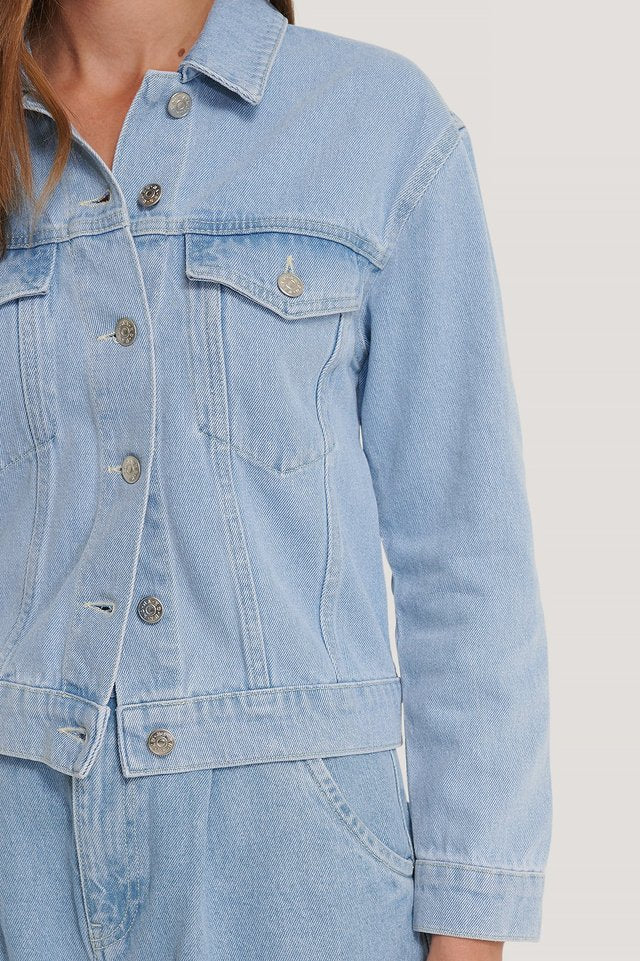 Light blue denim jacket with front pockets and button closure, perfect everyday casual wear for women.