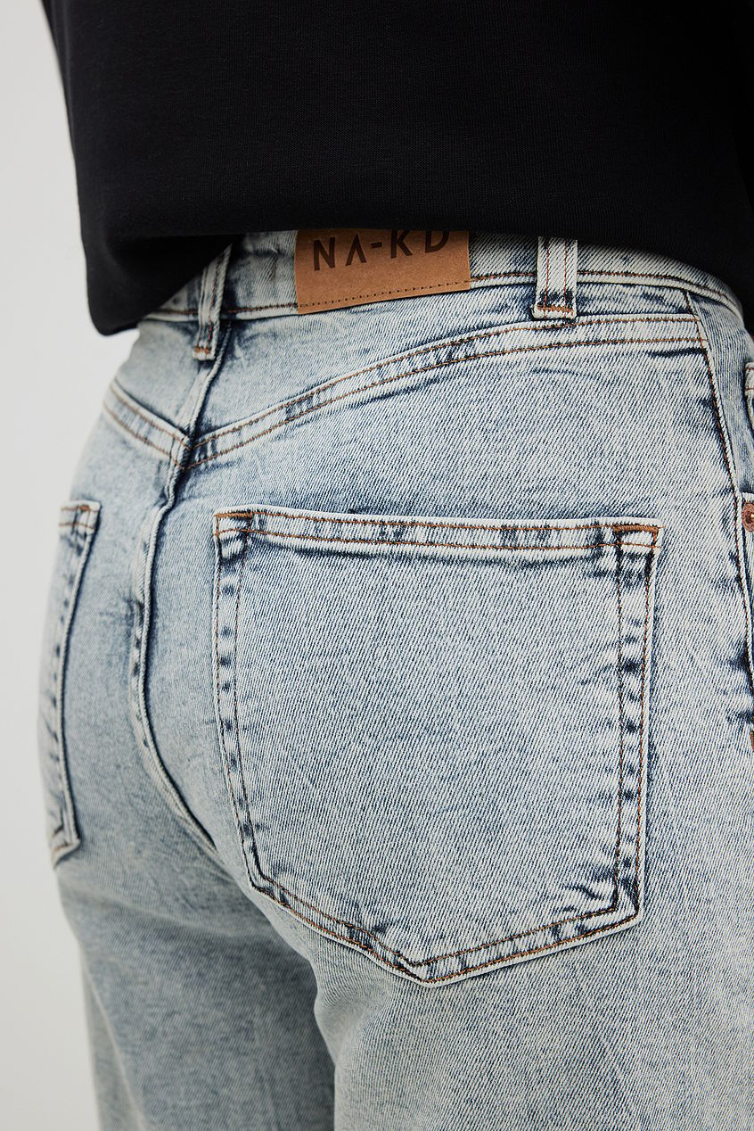 High-waisted organic mom jeans with relaxed straight leg design, displayed on a plain background.