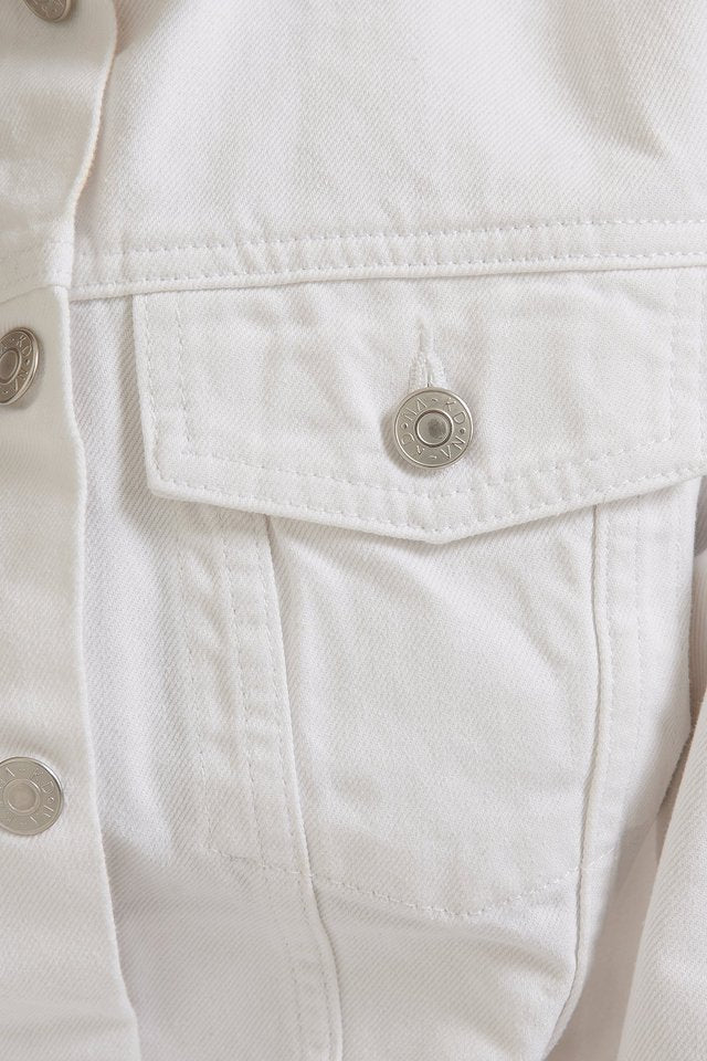 Crisp white denim jacket with stylish metal hardware details, perfect for all-season wear.