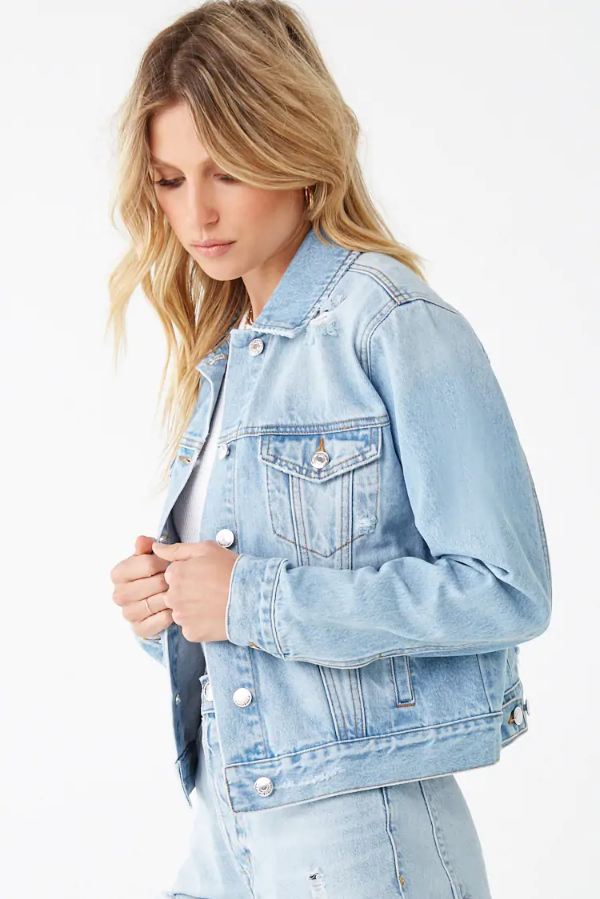 Light blue denim women's jacket with distressed details, showcased on a female model with long blonde hair.