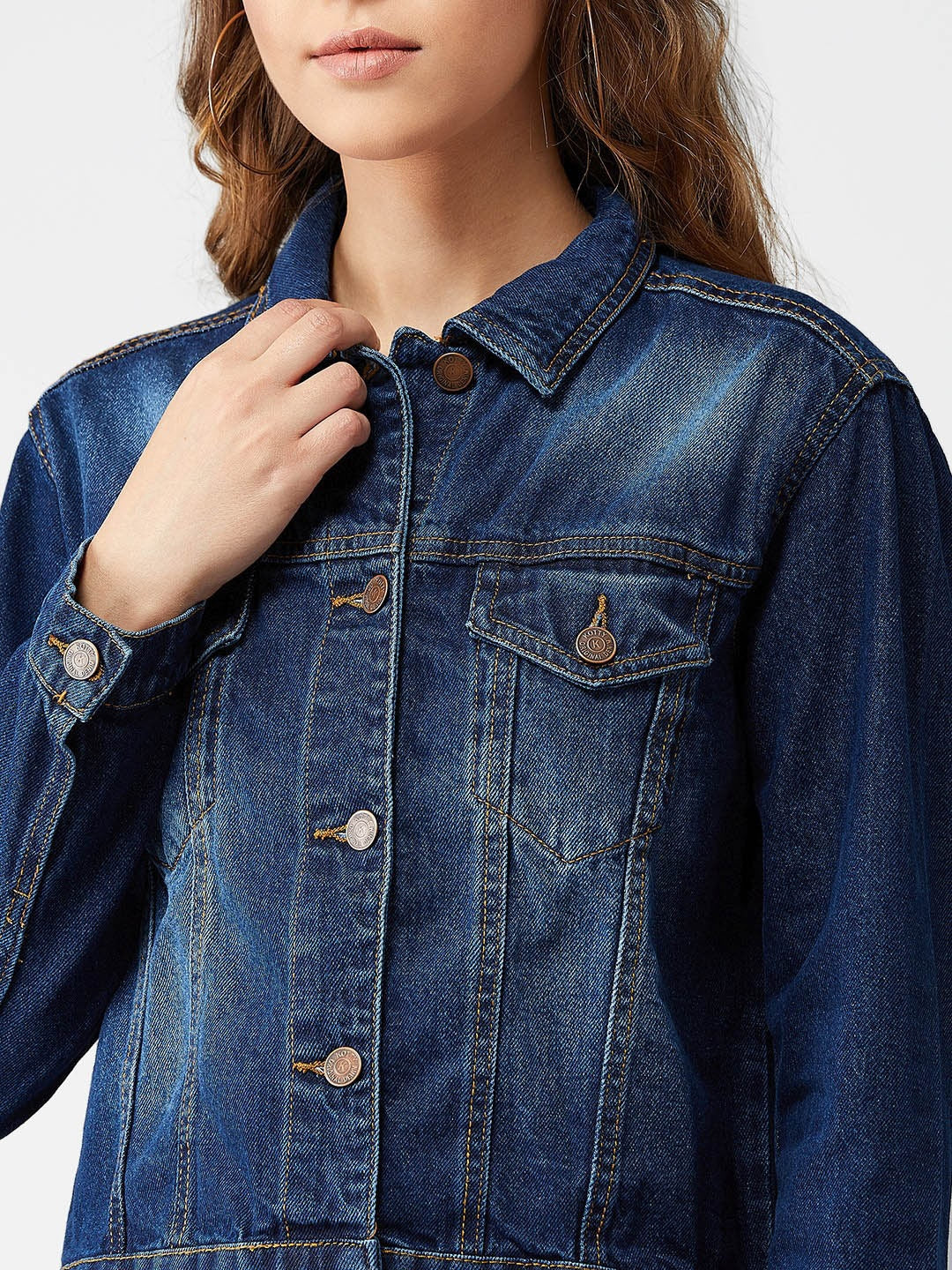Blue denim jacket with button-up closure, worn by female model in a casual setting.