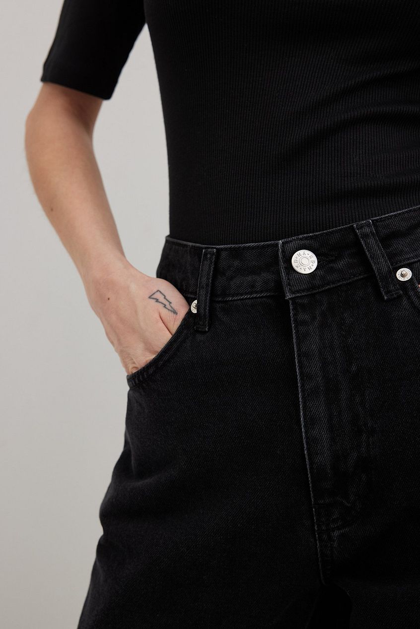 High-waist black denim jeans with a relaxed, wide-leg silhouette from Ace Cart.