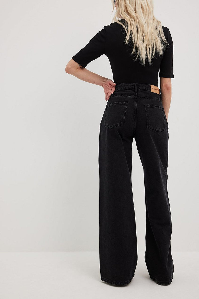 High-waist organic denim jeans with wide legs and a black top from Ace Cart.