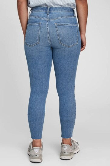 High-waisted ripped knee universal jeggings with stretch denim fabrication in a light blue wash, showcased on a model's lower body.