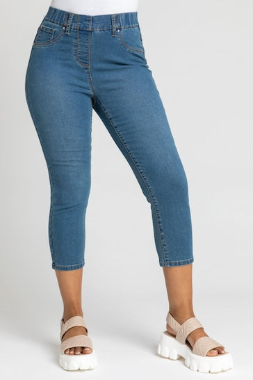 Relaxed-fit petite cropped jeggings with ripped knee detail, perfect for a casual chic look.