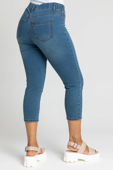 Stylish denim petite cropped jeggings with ripped knee detail, perfect for a casual and comfortable look.