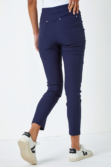 Navy blue high-waisted stretch jeggings with ripped knee detail, featuring a slim, form-fitting design for a flattering silhouette. Ideal for casual or dressed-up looks.