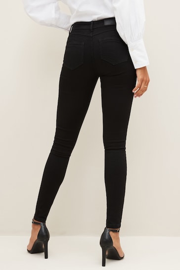 Sculpting stretch skinny black jeggings with a high-waisted design, featuring a slim fit and a classic five-pocket style.