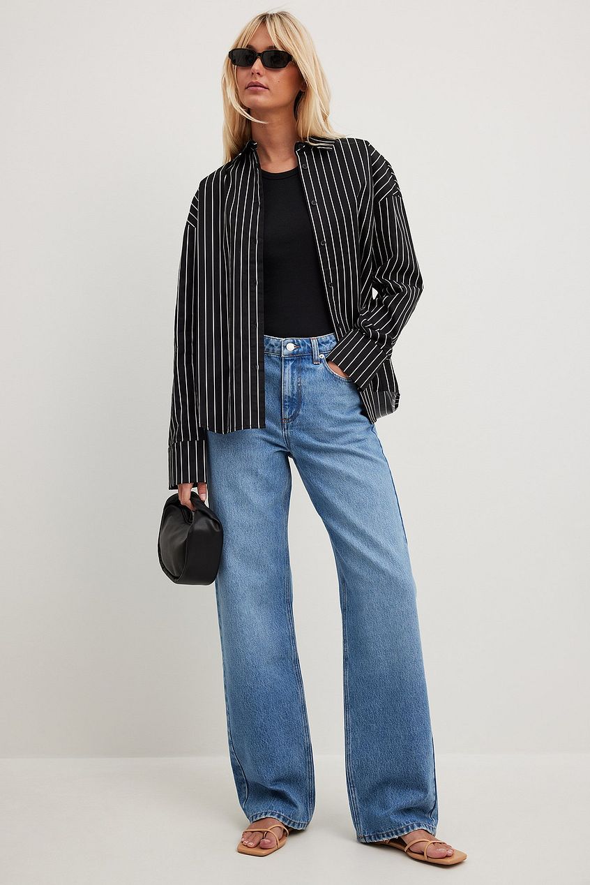 Loose mid-waist denim jeans, striped jacket, black sunglasses - stylish casual outfit for women.