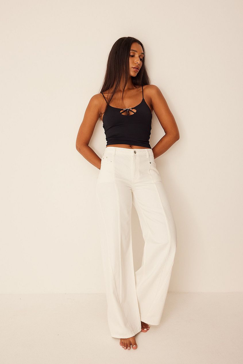 Mid Rise Straight Denim - Stylish white jeans with sleek silhouette, worn by a young woman against a neutral background.