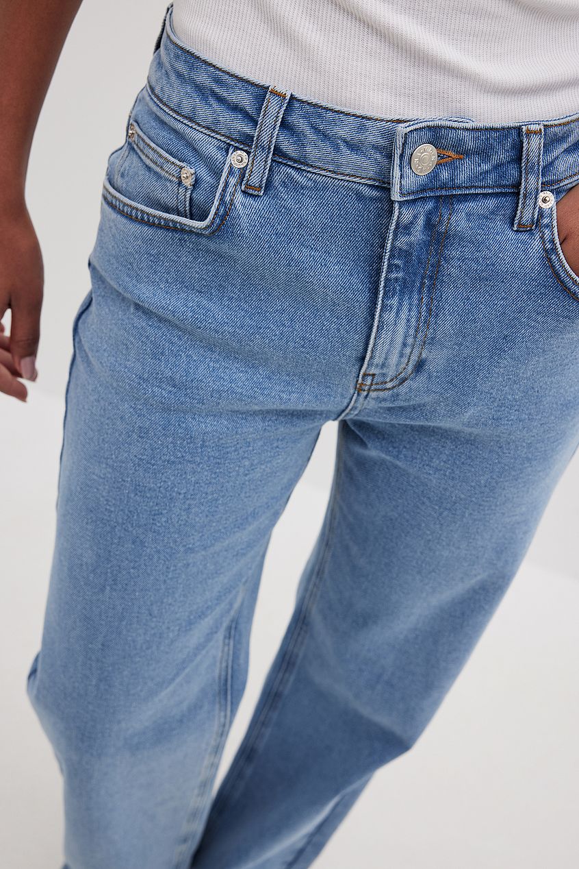 Mid Waist Denim Jeans - Classic blue denim with zipper and button closure, ideal for casual wear.