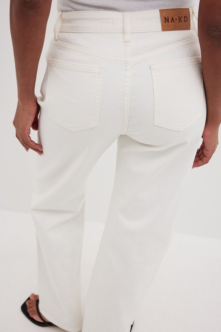 Tailored white denim jeans with Ace Cart branding, featuring a classic straight leg silhouette and front pockets for a modern, versatile look.
