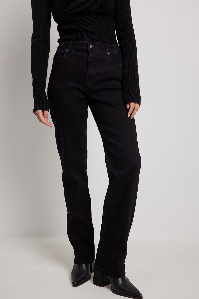 High-waist straight leg black denim jeans, minimal style, worn by female model on plain background.