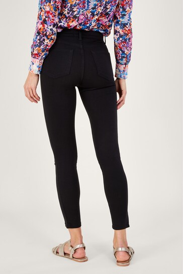 Vibrant floral print long-sleeved top paired with sleek black skinny jeggings, showcasing a stylish and versatile outfit.