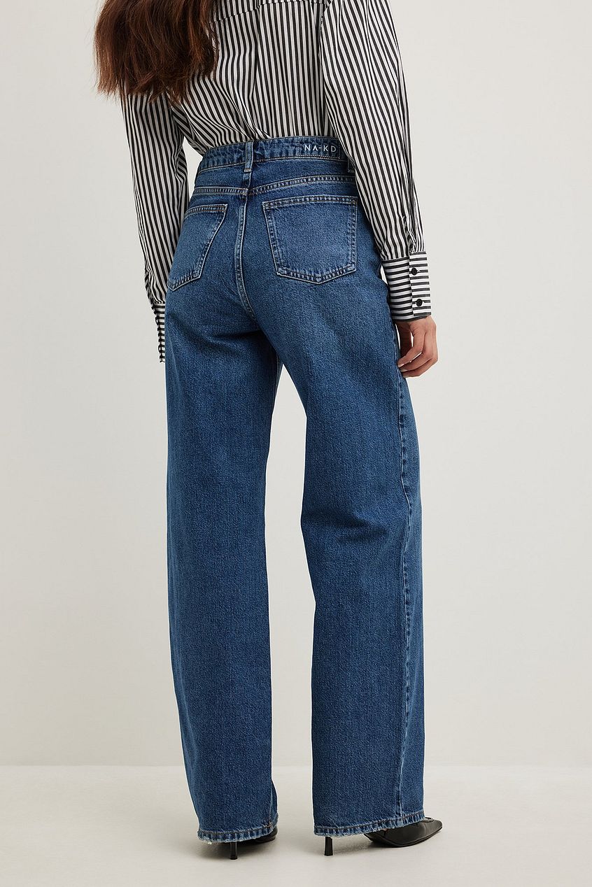 Wide high waist denim jeans with classic straight leg silhouette, worn by a model with a striped blouse against a plain white background.