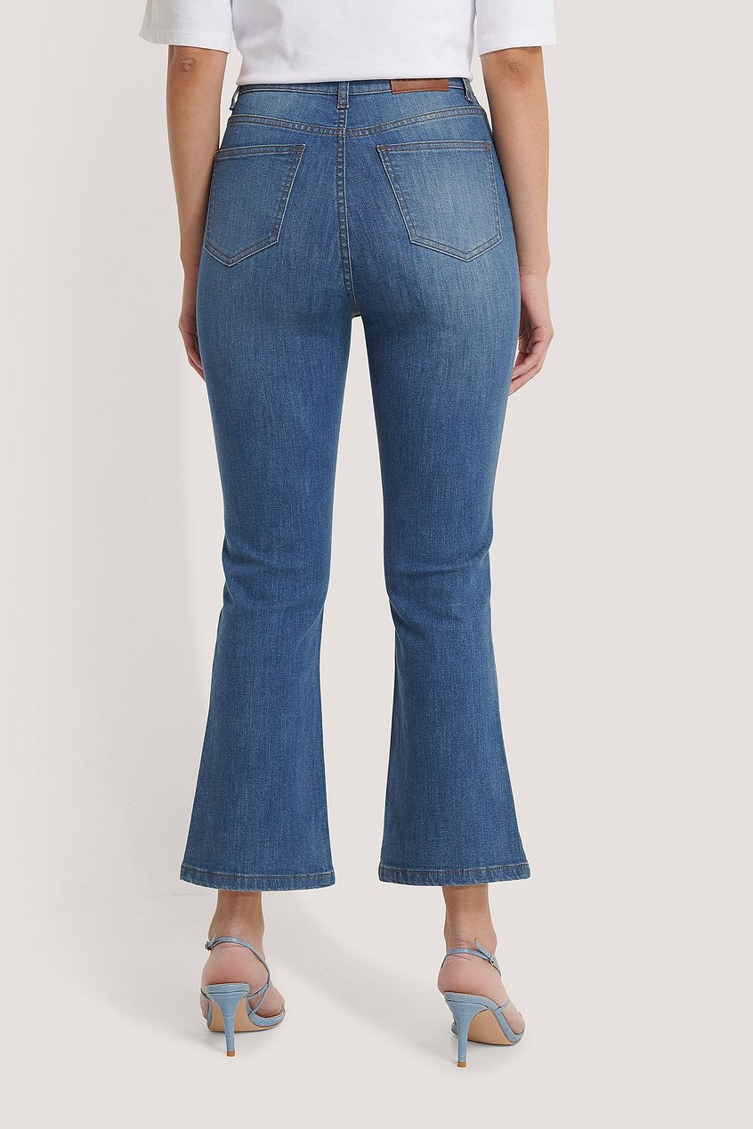 High-waist skinny denim jeans with a subtle flare at the hem, showcasing a relaxed yet stylish design.