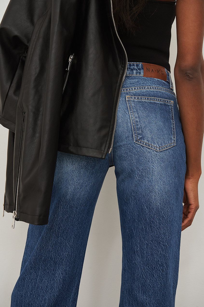 Slim Leg Denim Jeans: Classic blue denim jeans with a slim, straight leg fit showcased on a model against a plain background.