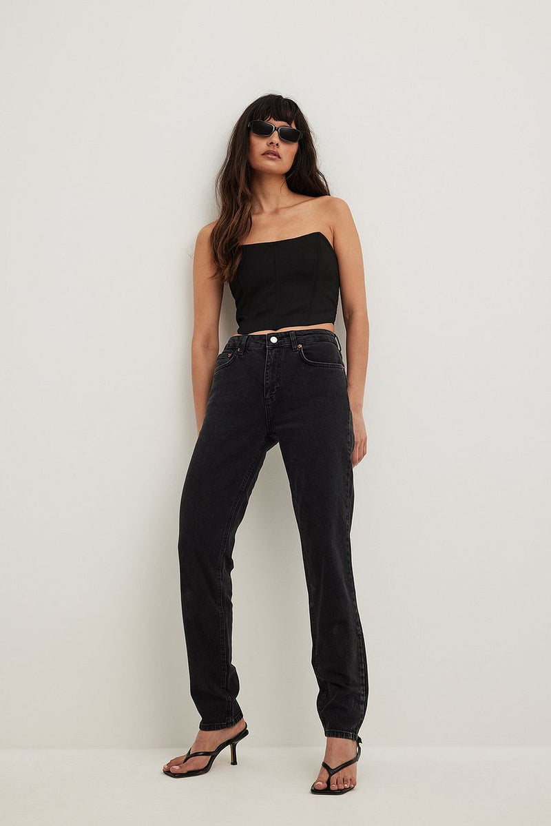Slim Mid Waist Denim Jeans from Ace Cart, black color with straight leg design, worn by model with black top and sunglasses against white background.